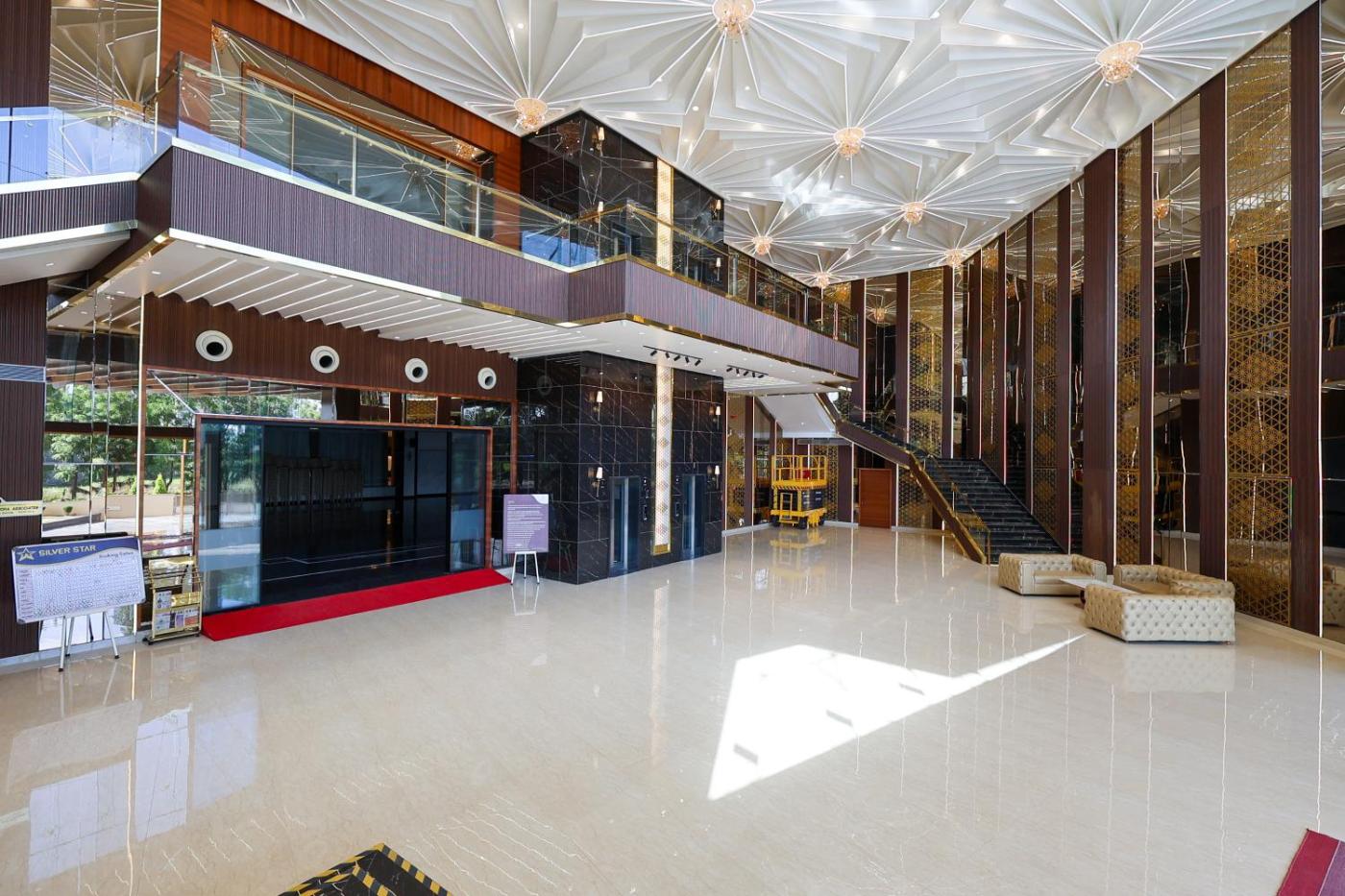 Arrival lobby with double-height ceiling and staircase at Silver Star, Amravati