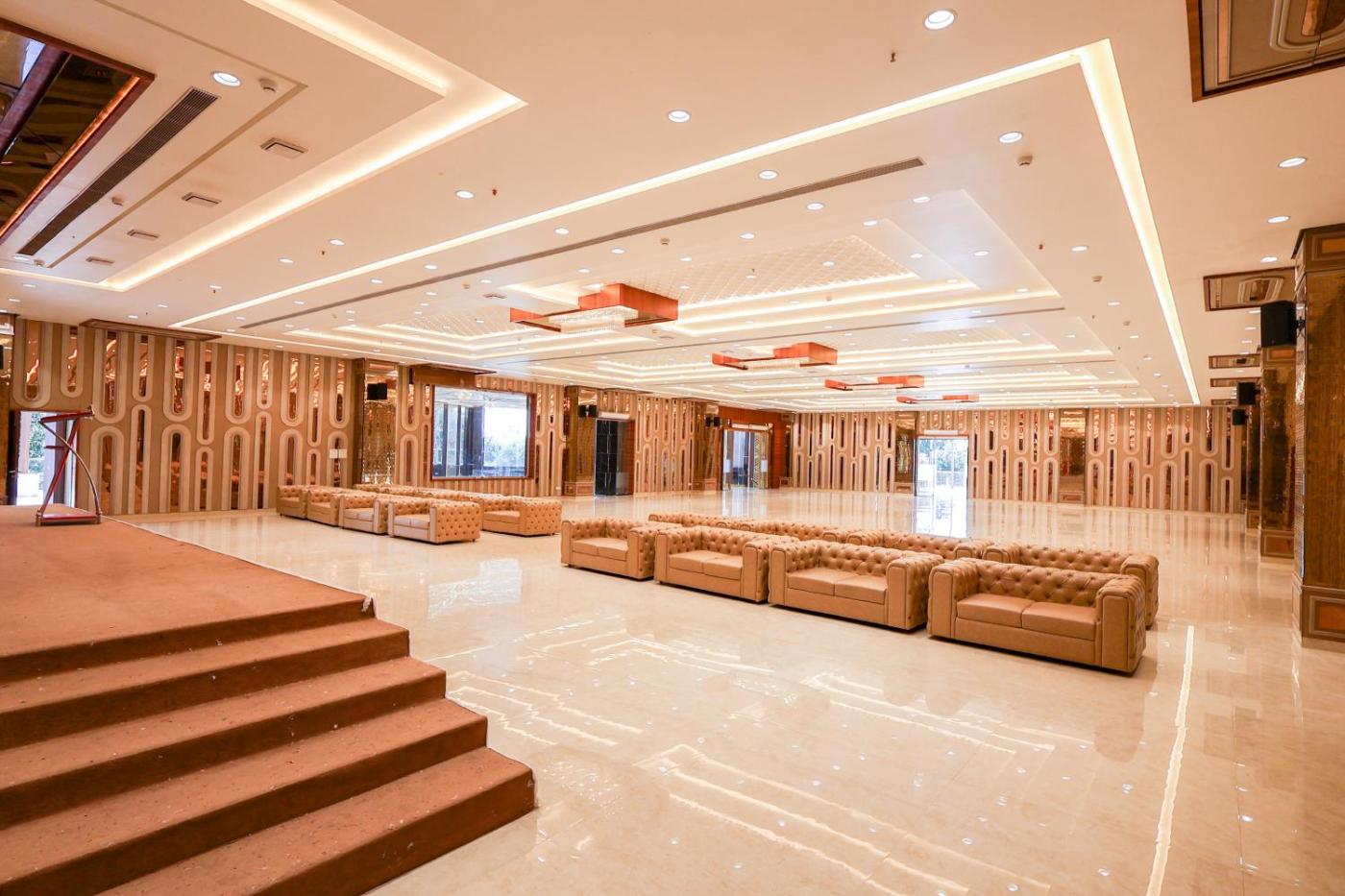 Banquet hall with stage steps and lounge seating at Silver Star, Amravati