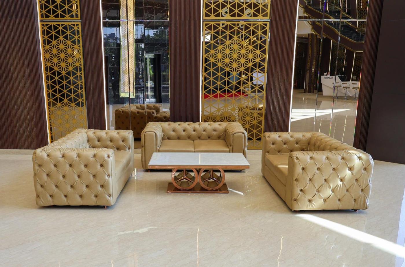 Gold tufted lounge sofas against a lattice backdrop at Silver Star, Amravati