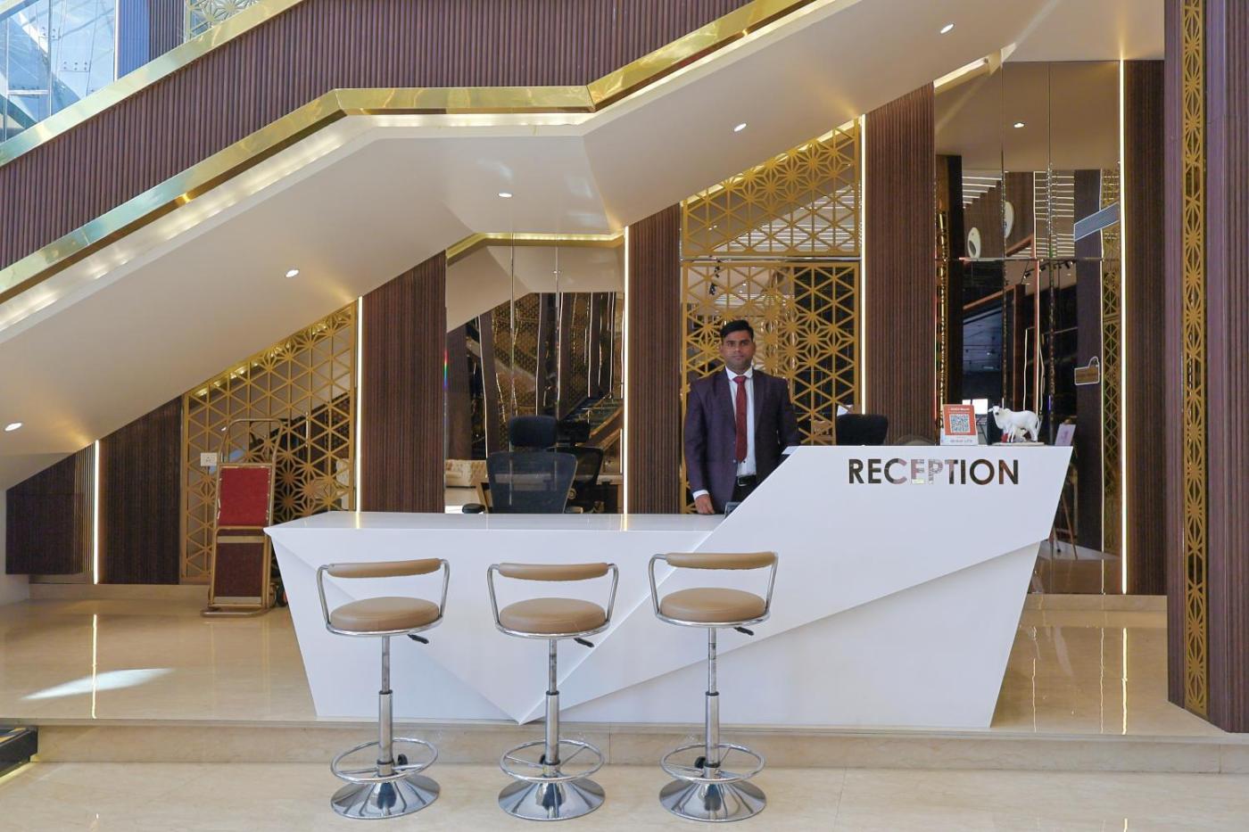 Reception desk with gold lattice backdrop at Silver Star, Amravati